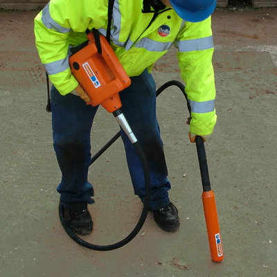 A Hand Held Poker - Electric being operated by a man in a high vis jacket.