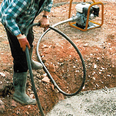 A Hand Held Poker - Petrol being operated by a person in a muddy area.
