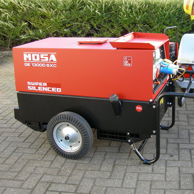 A 16kVA Silenced Road Tow Generator on a driveway outside a house.