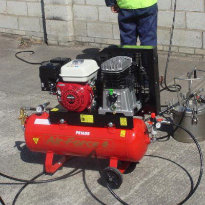 A Portable Petrol Compressor being used on a work site.