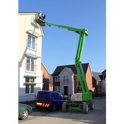 A Nifty HR17 Bi Energy / Hybrid Boom Lift - Articulated being operated to reach the top of a house.