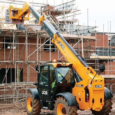 A Telehandlers being used to reach the upper levels of a house.