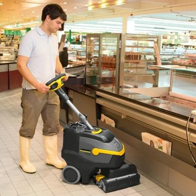 A Karcher (BR 35/12 C BP) Floor Scrubber Dryer being used to clean a supermarket.
