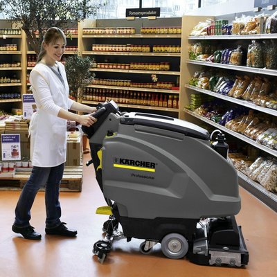 A Karcher (B40) Floor Scrubber Dryer being used by a person inside a supermarket.