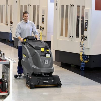 A Karcher (B80) Floor Scrubber Dryer being operated in a factory.