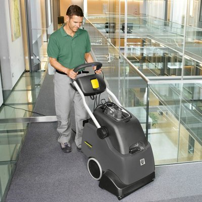 A Karcher (BRC 45/45 C) Professional Carpet Cleaner being used in an office building.