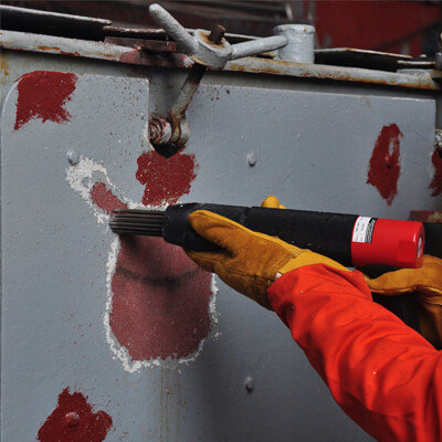 An Air Needle Gun being used on a panel.