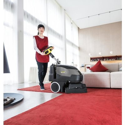 A Karcher (BRC 40/22) Commercial Carpet Cleaner being operated in a bedroom.