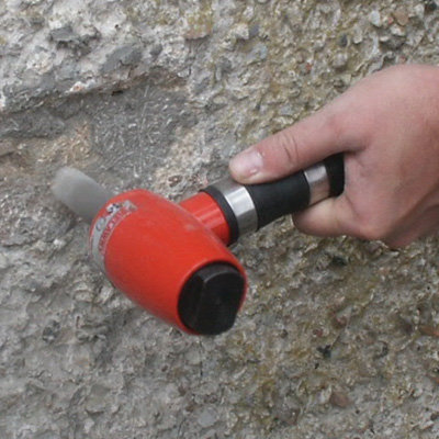 An Air Scabbler - 1 Head - Low Vibration being used on stone.