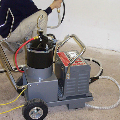 An Electric Paint Sprayer being used indoors.