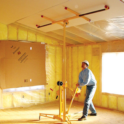 A Panel Lifter being operated by a man in a newly built home.
