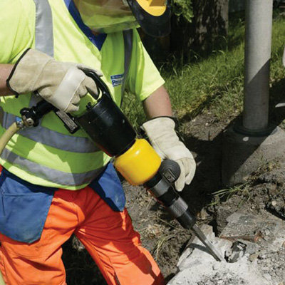 An Air Pick Medium Duty - Low Vibration being used to break up concrete.